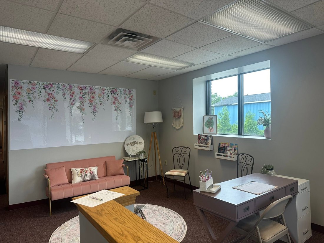 The welcome area at CoreLogic Learning with a soft couch and a wildflower wall